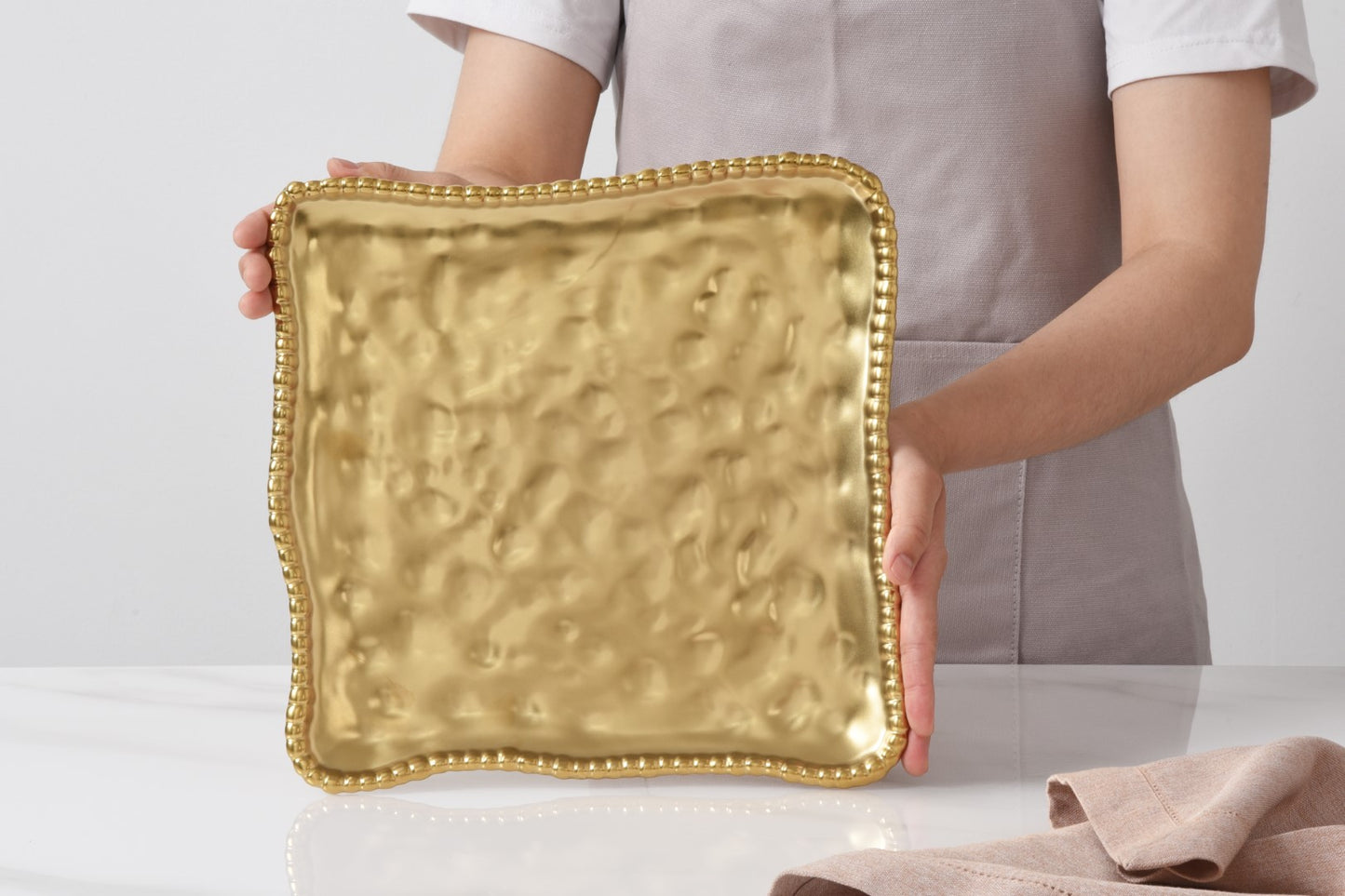 Monte Carlo Square Serving Platter in matte gold with beaded edge
Luxury gold porcelain square platter with hammered texture
Gold serving platter for appetisers, desserts, and entertaining