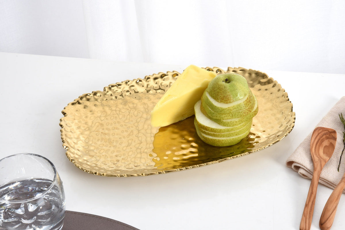 Pampa Bay Golden Millennium small platter in hammered gold porcelain styled on a table with cheese