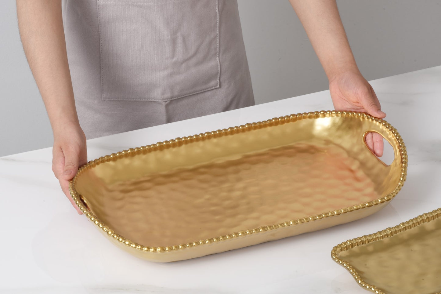 Monte Carlo Rectangular Tray With Handles in matte gold porcelain

Gold beaded rectangular serving tray with integrated handles

Luxury matte gold Pampa Bay porcelain tray for serving and décor